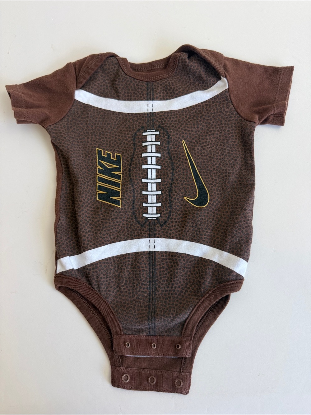 Nike Brown and White Football Graphic Baby Bodysuit with Yellow Accents
